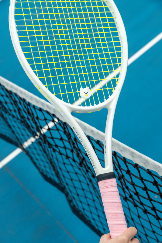 A Pupcourt cavoodle overgrip on the handle and a matching dampener in the strings, at the net
