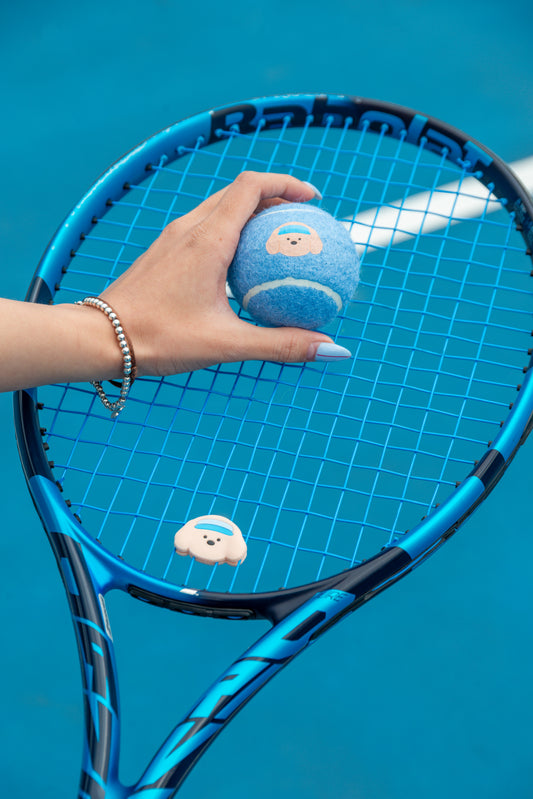 pwp-pdp-add-2026-08-02 tennis-dampener-bright B227 — The Pupcourt golden retriever dampener fitted to racket strings
